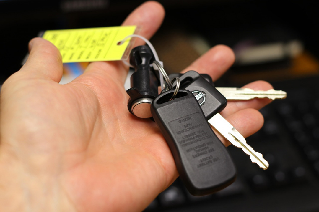 Hand holding car keys